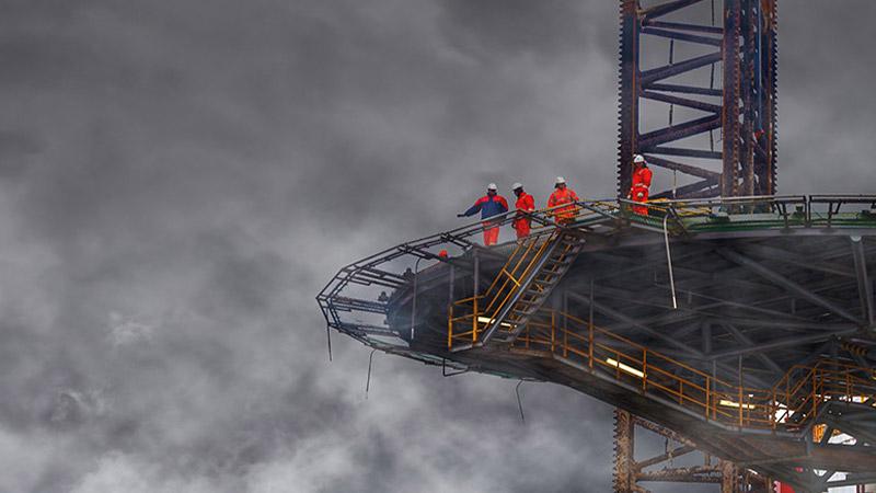 Workers on an elevated deck of a boat