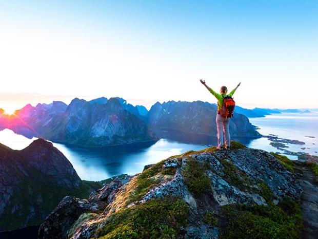 Arms raised on a mountain